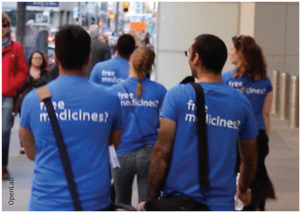 Photograph of members of the research team, dressed in blue tshirts that are branded with "Free Medicines?", canvassing downtown Toronto for community guidance panel members.