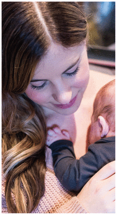 Close-up photo of Becca Mintz holding her baby against her shoulder.