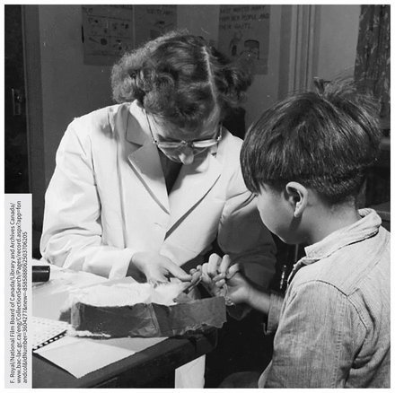 Nurse taking a blood sample from a boy at the Alberni Indian Residential School (Port Alberni, BC) as part of a series of nutrition experiments conducted in residential schools between 1948 and 1952.